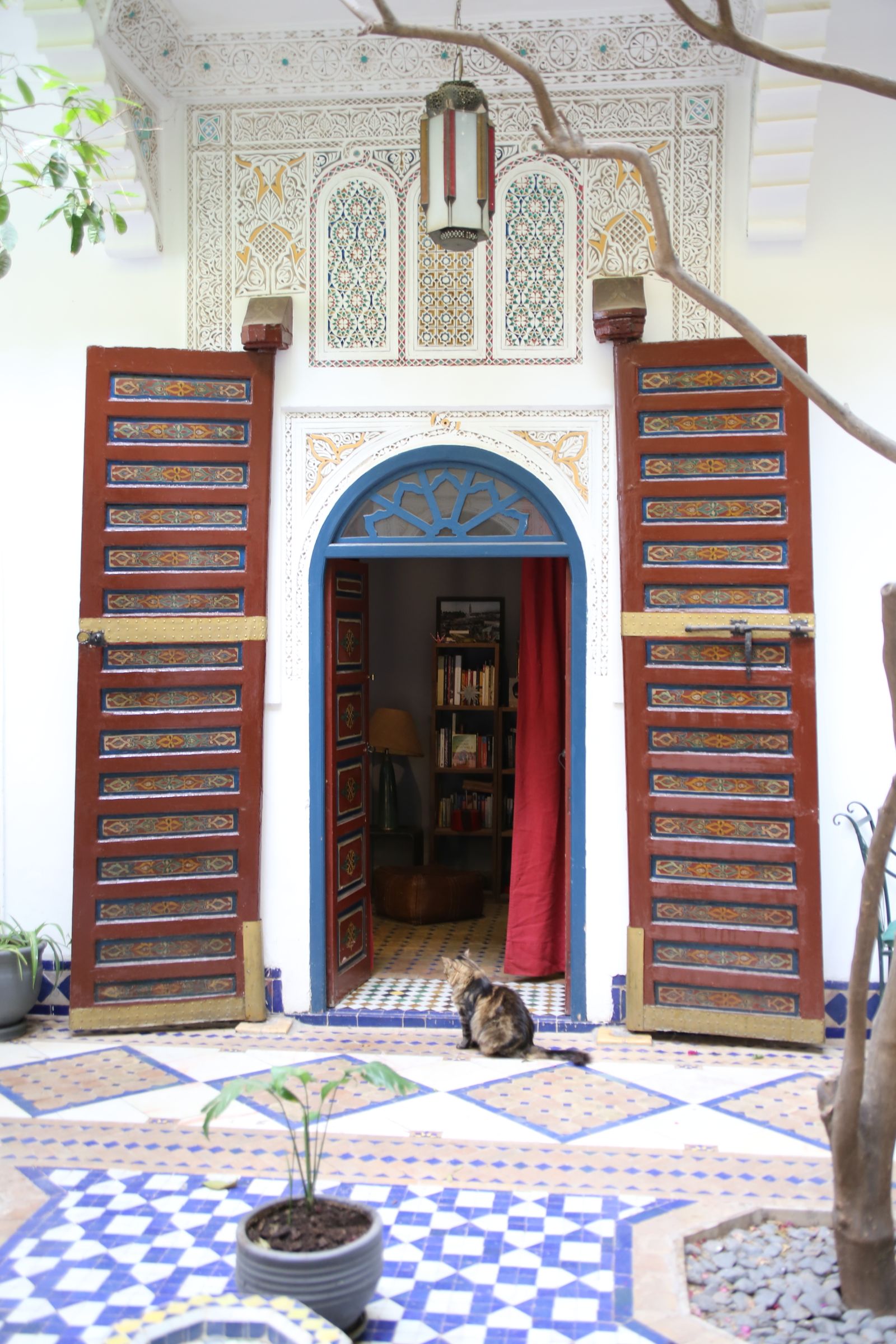 Riad courtyard with tiled fountain and orange trees